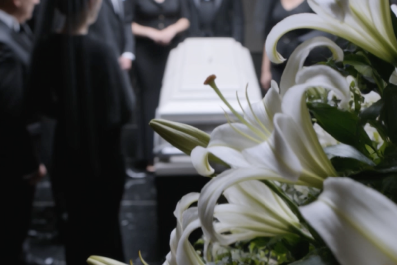 For one long second, nobody in the funeral parlor moved.